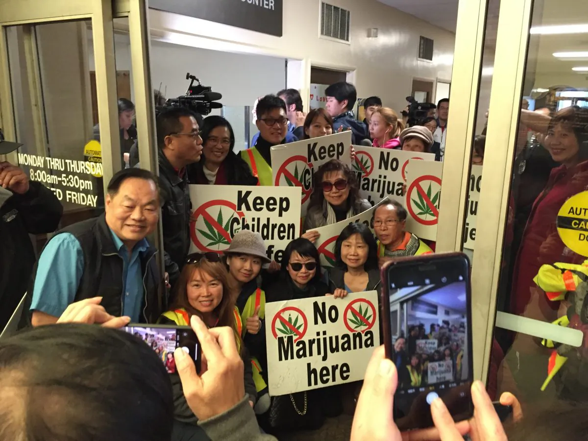 Opponents of a marijuana project take pictures at the east entrance of the El Monte City Hall on Feb. 6, 2019 after submitting thousands of signatures collected for a referendum petition to repeal the city's approval of a cannabis facility. (Zach Li/The Epoch Times)