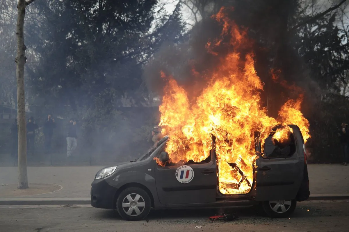 A burning command car belonging to France's anti-terror 'Vigipirate' squad, dubbed 'Operation Sentinelle', is pictured during a demonstration as yellow vests protesters keep pressure on French President Emmanuel Macron's government, for the 13th straight weekend of demonstrations, in Paris, France, on Feb. 9, 2019. (Kamil Zihnioglu/AP Photo)