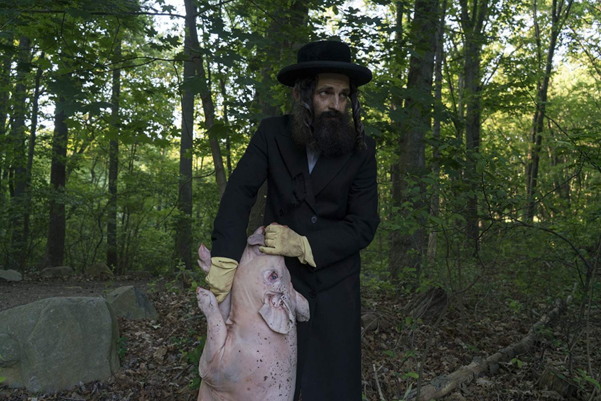 Hasidic Jewish man and dead pig