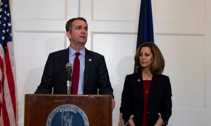 Virginia Governor Ralph Northam, flanked by his wife Pam, speaks with reporters at a press conference at the Governor's mansion in Richmond, Virginia, on Feb. 2, 2019. (Alex Edelman/Getty Images)