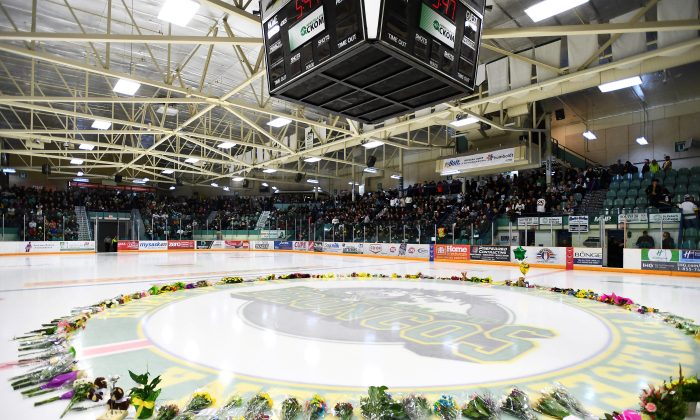 Flowers lie on the ice as people gather for a vigil at the Elgar Petersen Arena, home of the Humboldt Broncos, on April 8, 2018. Saskatchewan's privacy commissioner has found eight people inappropriately gained access to electronic health records of 10 Humboldt Broncos team members in reports released Jan. 31, 2019. (Jonathan Hayward/Pool via REUTERS)