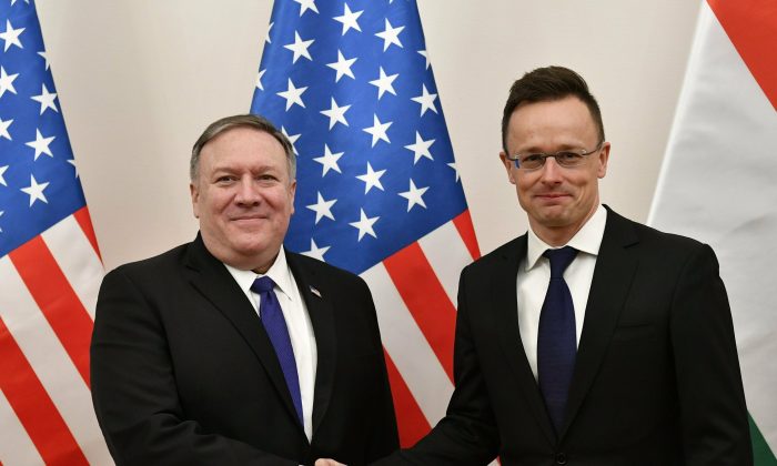 Hungarian Minister of Foreign Affairs and Trade Peter Szijjarto, right, shakes hands with U.S. Secretary of State Mike Pompeo in the ministry in Budapest, Hungary, on Feb. 11, 2019. (Zsolt Szigetvary/MTI via AP)