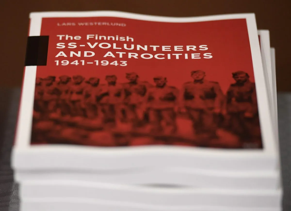 The research document entitled The Finnish SS-volunteers and atrocities 1941 - 1943 against Jews, detailing atrocities against civilians and Prisoners of War in Ukraine and the Caucasus Region, pictured in Helsinki, Finland, on Feb. 8, 2019. (Heikki Saukkomaa/Lehtikuva via AP)