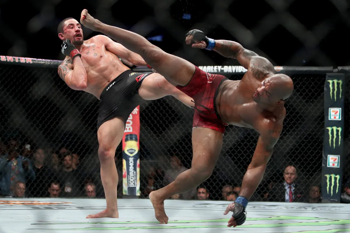 Robert Whittaker of New Zealand (L) and Yoel Romero of Cuba (R) each attempt a kick in the fifth round in their middleweight title fight during the UFC 225: Whittaker v Romero 2 event at the United Center on Jun. 9, 2018 in Chicago, Ill. (Dylan Buell/Getty Images)