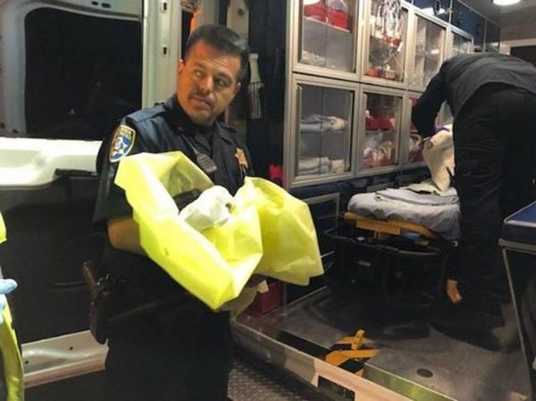 California Highway Patrol officer holds abandoned infant
