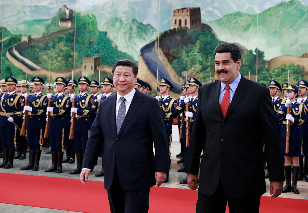 Venezuela's President Nicolas Maduro (R) walks with Chinese leader Xi Jinping (L) as they arrive to a welcoming ceremony at the Great Hall of the People in Beijing on Jan. 7, 2015. (Andy Wong-Pool/Getty Images)