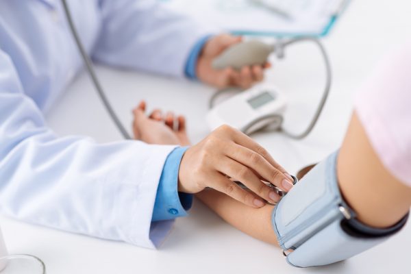 Doctor taking pulse of the patient