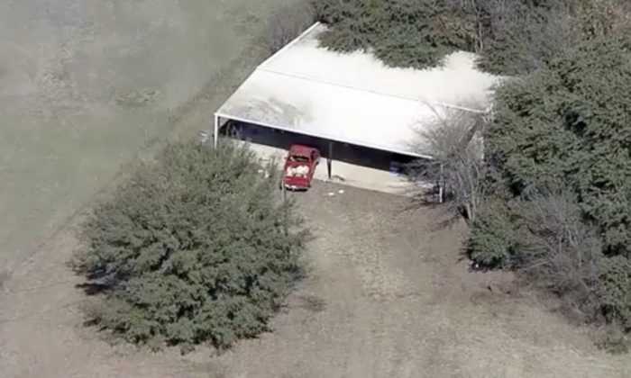 Part of the property where deputies found two young, malnourished children locked together in a dog cage near Rhome, Texas on Feb. 12, 2019. (AP Photo/KDFW-FOX4 News)