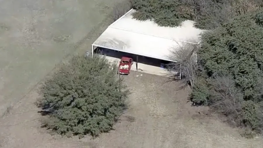 Part of the property where deputies found two young, malnourished children locked together in a dog cage near Rhome, Texas on Feb. 12, 2019. (AP Photo/KDFW-FOX4 News)