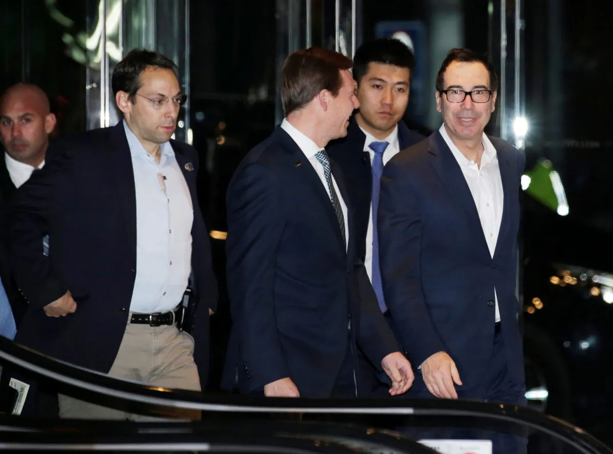 U.S. Treasury Secretary Steven Mnuchin (R), a member of the U.S. trade delegation to China, arrives at a hotel in Beijing on Feb. 12, 2019. (Jason Lee/Reuters)