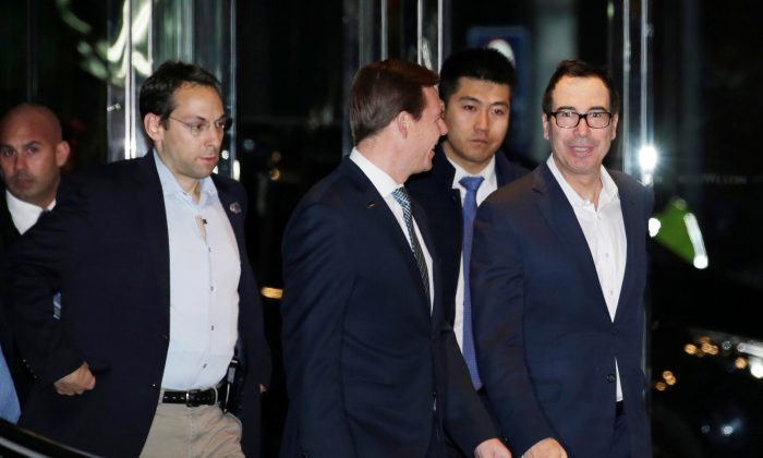 U.S. Treasury Secretary Steven Mnuchin (R), a member of the U.S. trade delegation to China, arrives at a hotel in Beijing on Feb. 12, 2019. (Jason Lee/Reuters)