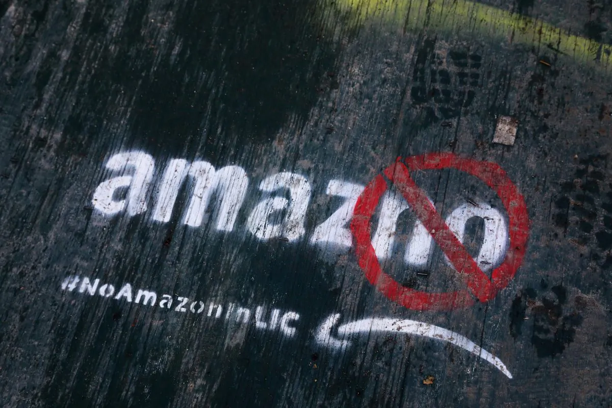 Graffiti painted on a sidewalk by someone opposed to the location of an Amazon headquarters in the Long Island City neighborhood in the Queens borough of New York, photo taken on Nov. 16, 2018. (AP Photo/Mark Lennihan, File)