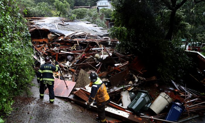 Southern Marin firefighters search a home that was swept down a hill by a mudslide during a rain storm on February 14, 2019 in Sausalito, California. 50 homes in the town of Sausalito were evacuated after a mudslide struck homes and sent at least one sliding 75 yards down a hill. No injuries were reported. (Photo by Justin Sullivan/Getty Images)