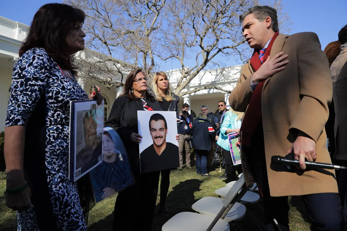 CNN's Jim Acosta (R) talks with 'Angel moms,' including Sabine Durden (L), following a news conference with U.S. President Donald Trump in the Rose Garden at the White House in Washington, on Feb. 15, 2019. (Chip Somodevilla/Getty Images)