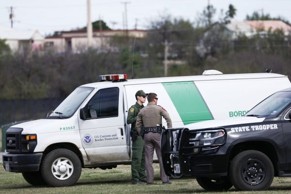 Border Patrol agents and Texas State Troopers line the Rio Grande in Eagle Pass