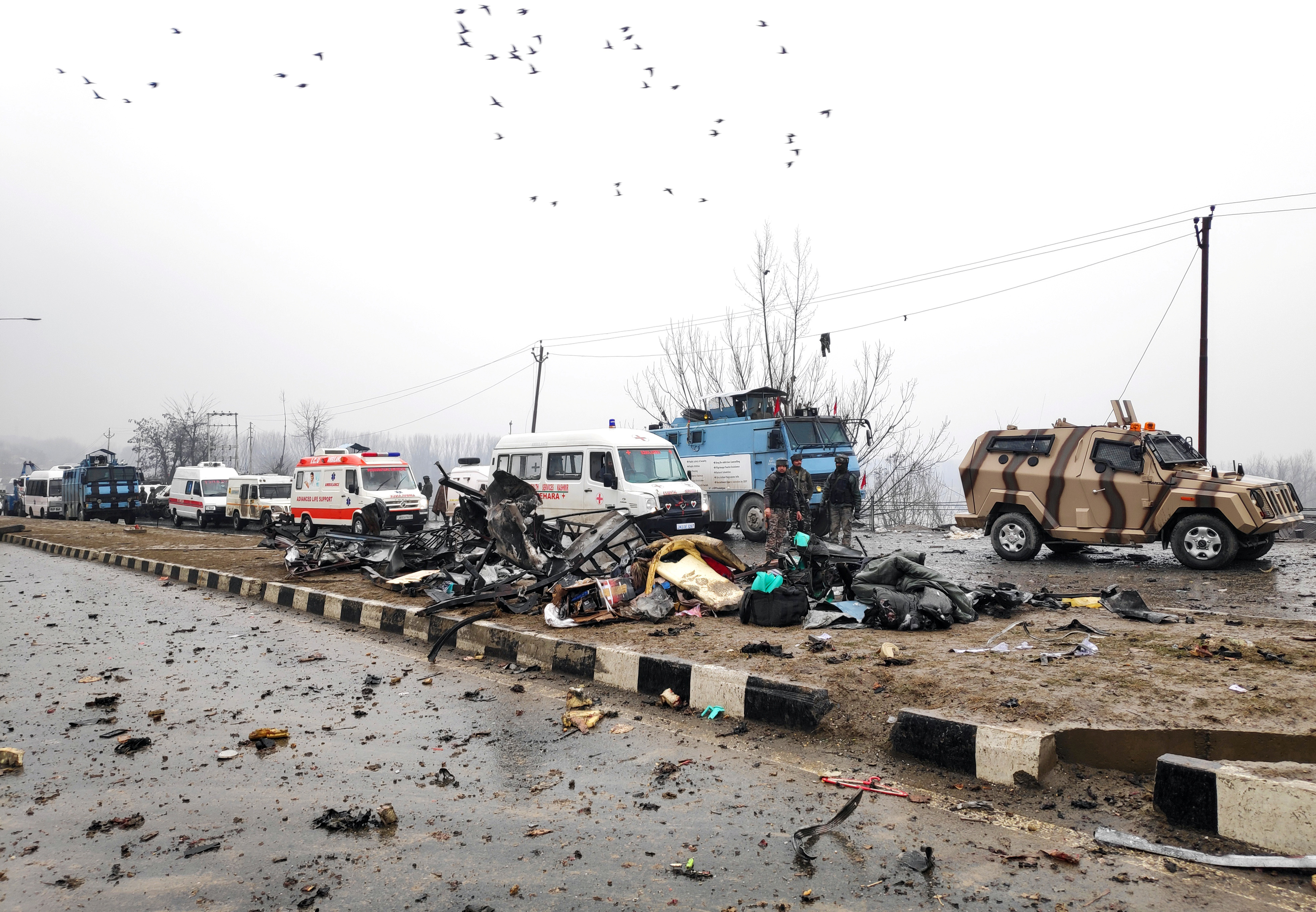 Indian soldiers examine the debris after an explosion 