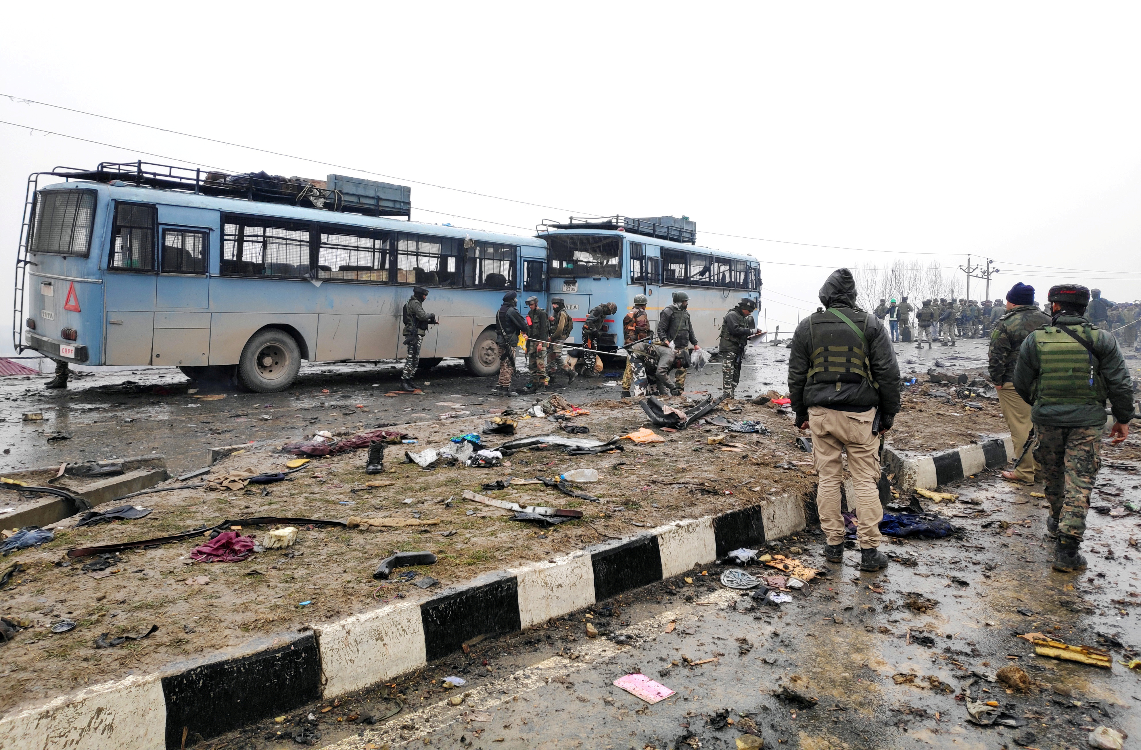 Indian soldiers examine the debris after an explosion