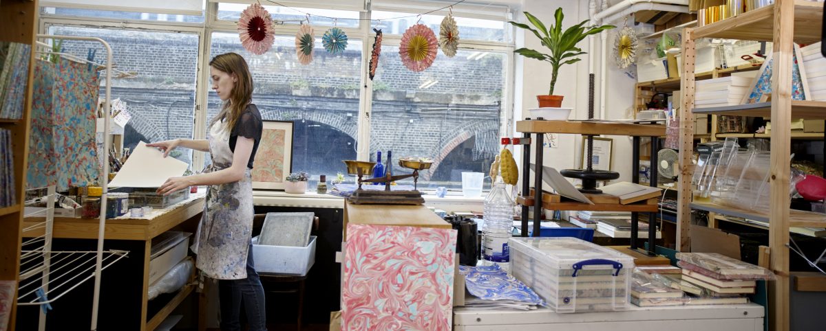 Lucy McGrath in her paper-marbling studio. Paper marbling is a critically endangered craft in the UK. (Rankin Studios)
