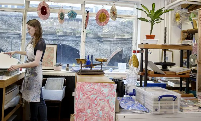 Lucy McGrath in her paper-marbling studio. Paper marbling is a critically endangered craft in the UK. (Rankin Studios)
