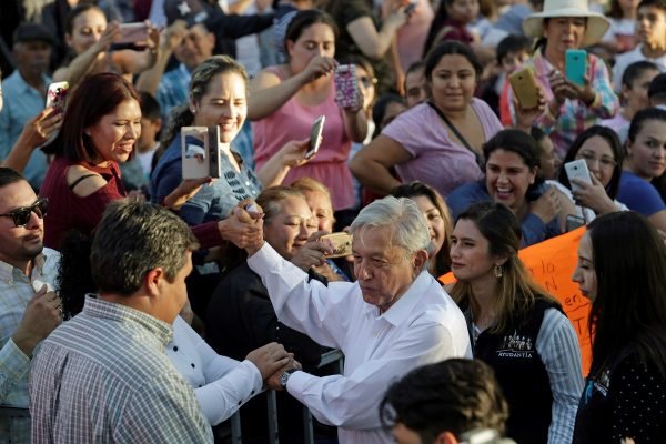 Mexico's President Andres Manuel Lopez Obrador greets people during his arrival to an event in Badiraguato