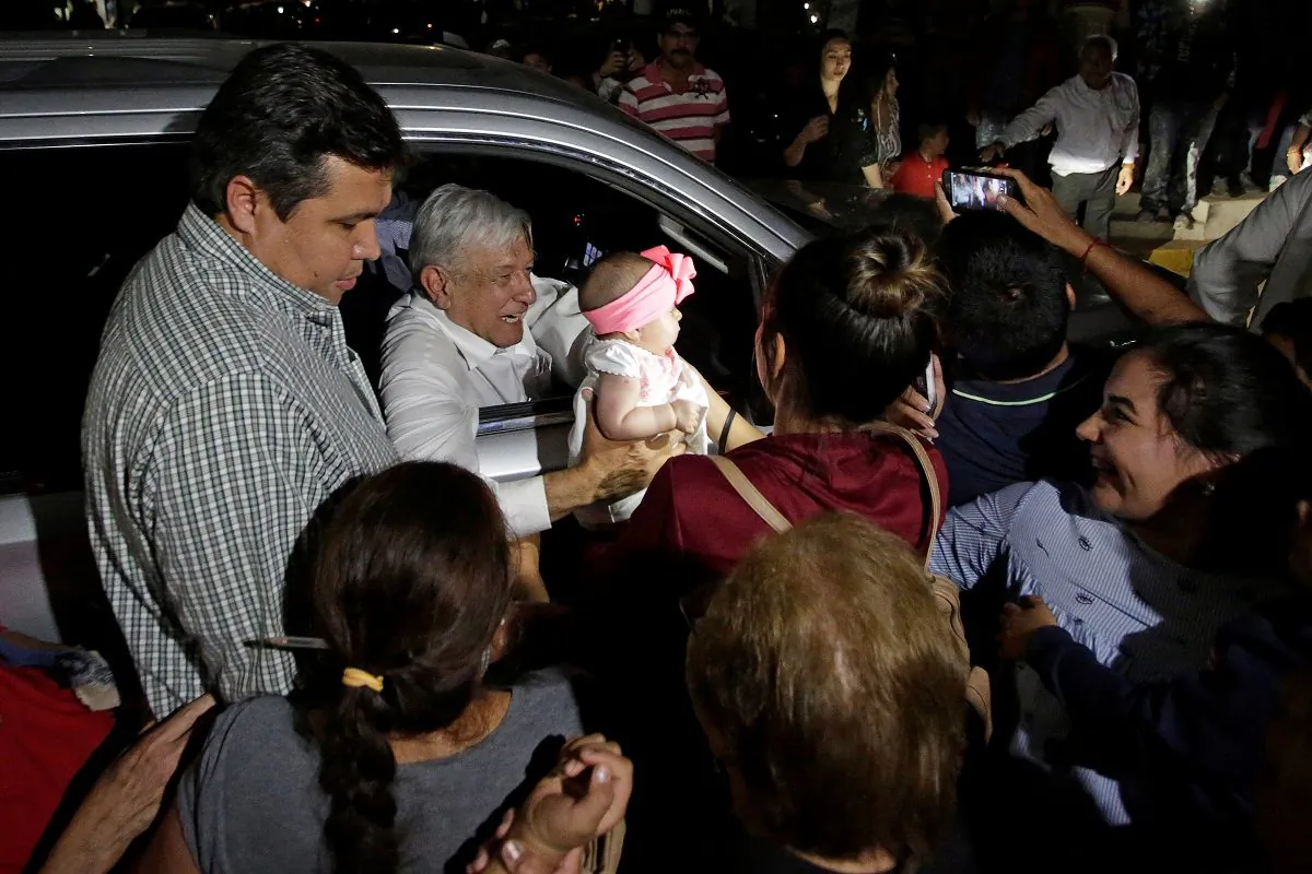 Mexico's President Andres Manuel Lopez Obrador holds a baby while leaving an event in Badiraguato, in the Mexican state of Sinaloa, Mexico, on Feb. 15, 2019. (Daniel Becerril/Reuters)