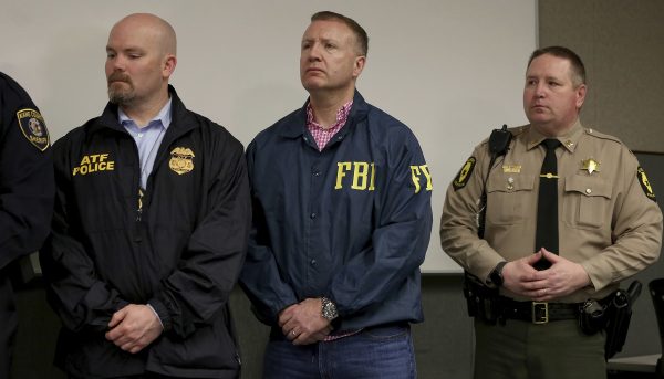 Representatives of law enforcement agencies attend a news conference