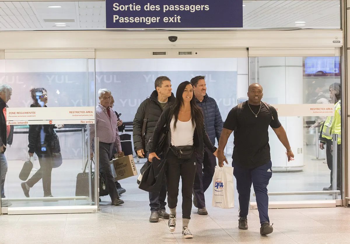 Passengers arrive at Trudeau airport in Montreal on Feb. 16, 2019. More than 100 Quebec tourists who had been trapped in Haiti amid violent street protests were flown back to Montreal that day. (THE CANADIAN PRESS/Graham Hughes)