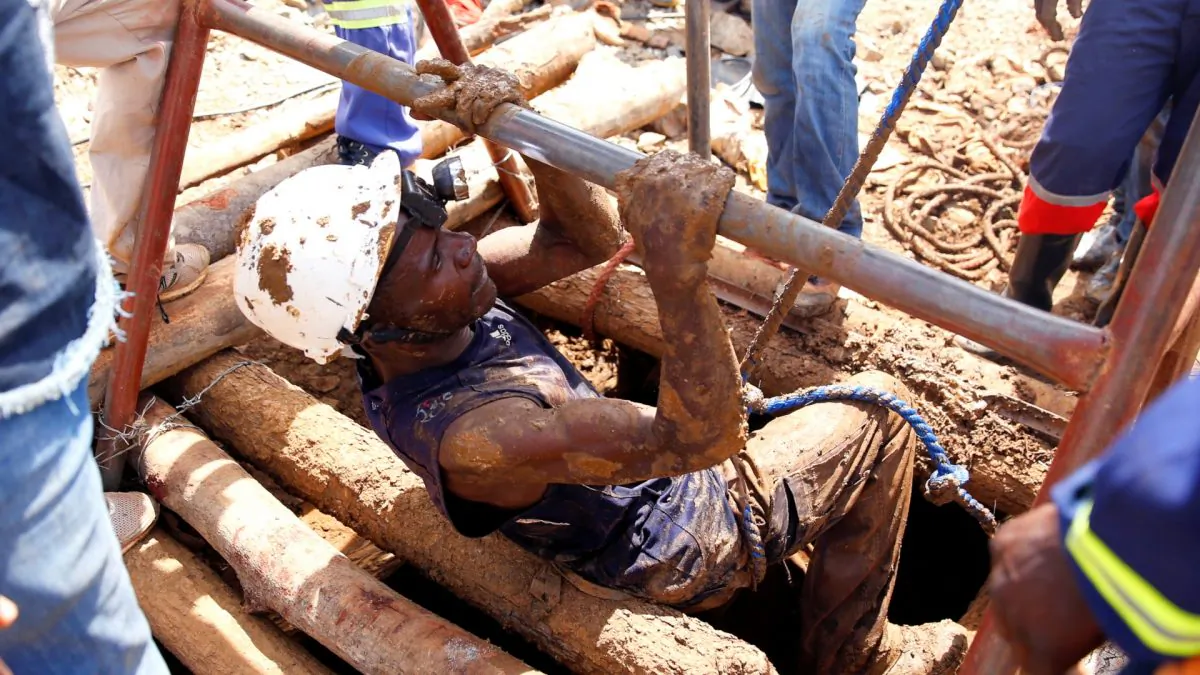 A mine rescuer climbs of a shaft as retrieval efforts proceed for trapped illegal gold miners in Kadoma, Zimbabwe, on Feb. 15, 2019. (Philimon Bulawayo/Reuters)