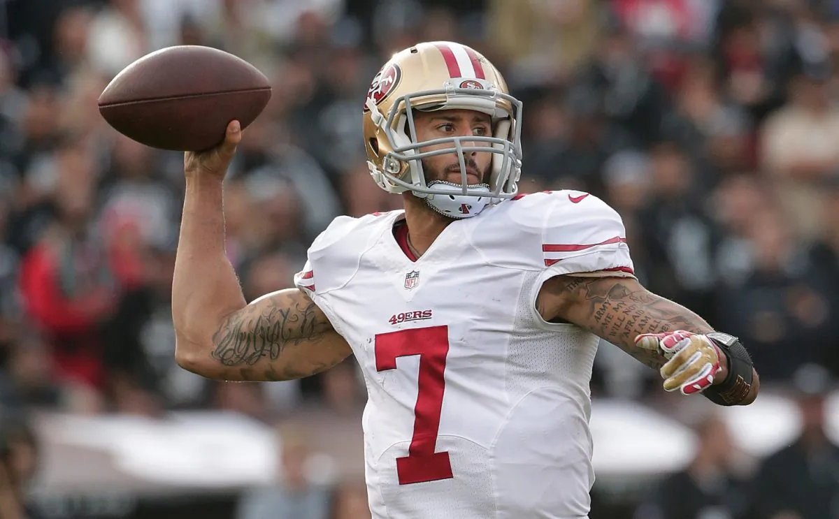 File photo showing now former San Francisco 49ers quarterback Colin Kaepernick passing against the Oakland Raiders during the second quarter of an NFL football game in Oakland, Calif., Sunday, Dec. 7, 2014. (AP Photo/Marcio Jose Sanchez)