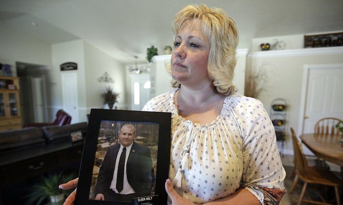 Laurie Holt holds a photograph of her son Joshua Holt at her home in Riverton, Utah. On July 13, 2016. (AP Photo/Rick Bowmer)
