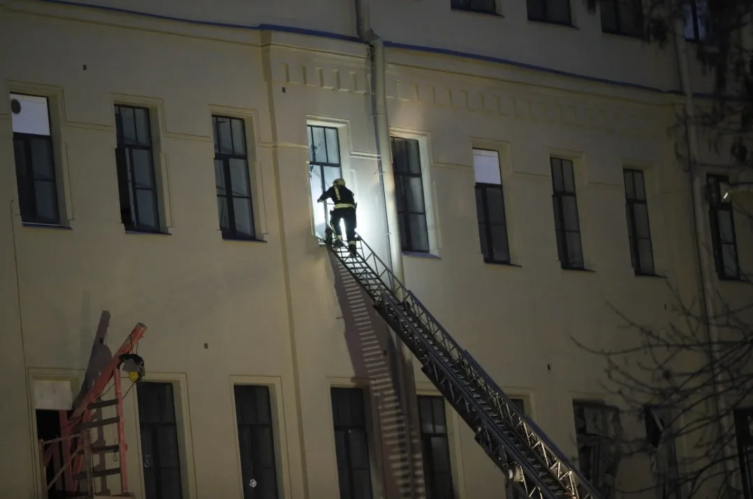 A Russian Emergency employee tries to get inside the collapsed building of the Saint Petersburg National Research University of Information Technologies, Mechanics and Optics in St. Petersburg, Russia, on Feb. 16, 2019. Russian emergency authorities say several floors of a university building in Russia's second-largest city have collapsed. (AP Photo/Dmitri Lovetsky)