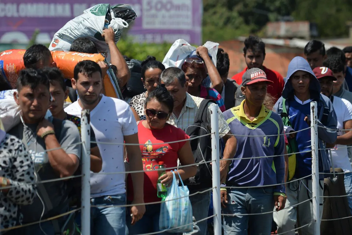 People cross the Simon Bolivar International bridge from Cucuta, Colombia to San Antonio, Tachira, Venezuela, on Feb. 16, 2019. Venezuelan opposition leader Juan Guaido on Feb. 16 called for nationwide protests next week to support volunteers planning to travel to the border with Colombia to bring in US humanitarian aid. (Luis Robayo/AFP/Getty Images)
