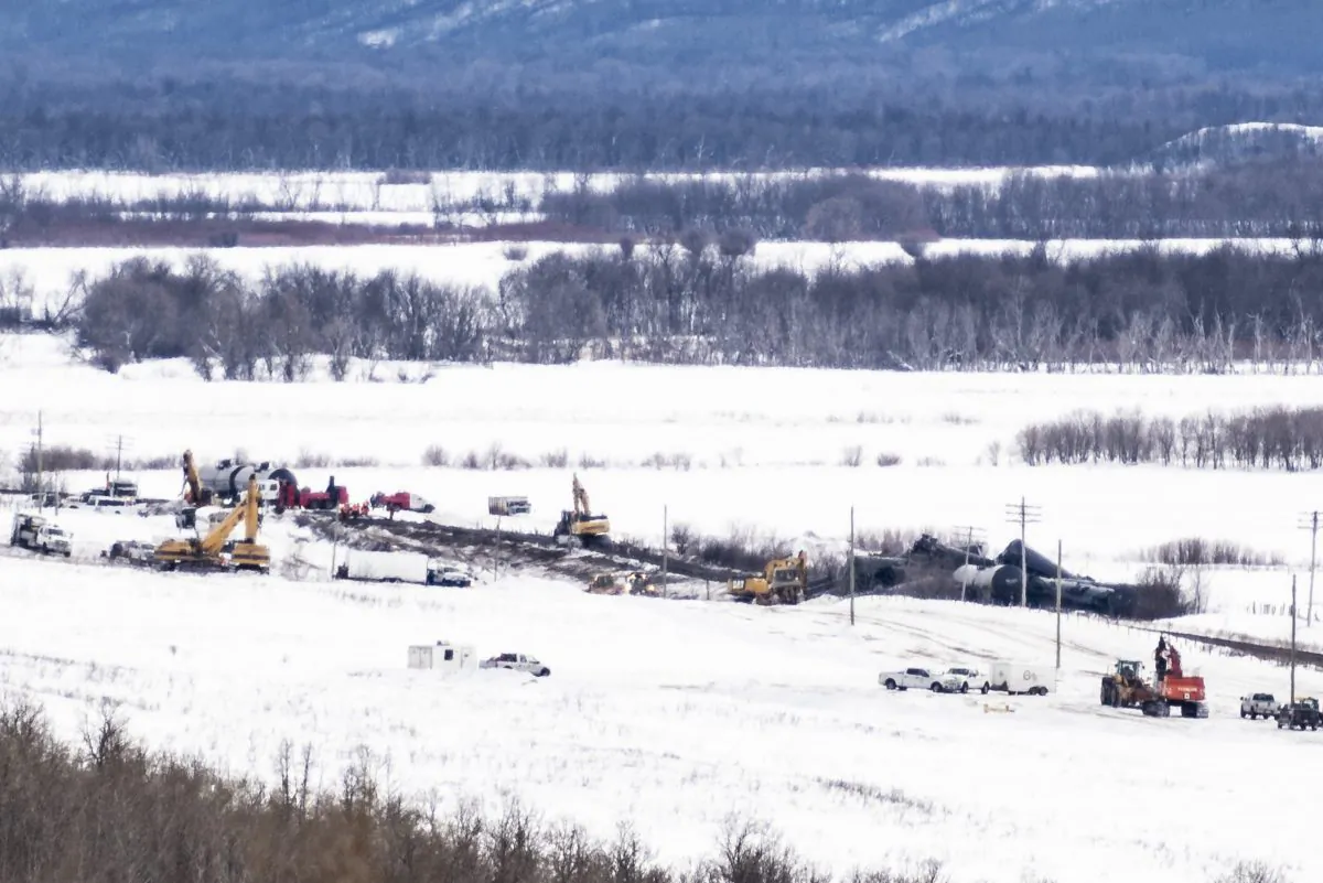 Excavators work at the site of a train derailment ten-kilometres south of St. Lazare, Man. on Feb. 16, 2019. (The Canadian Press/Michael Bell)