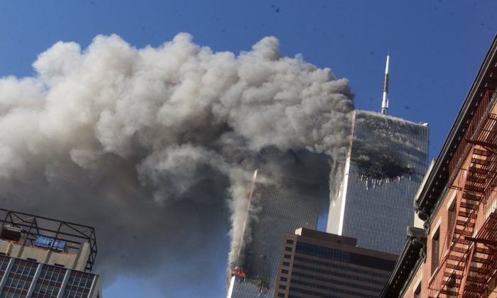 Smoke rises from the burning twin towers of the World Trade Center after hijacked planes crashed into the towers, in New York City on Sept. 11, 2001. (Richard Drew/AP)