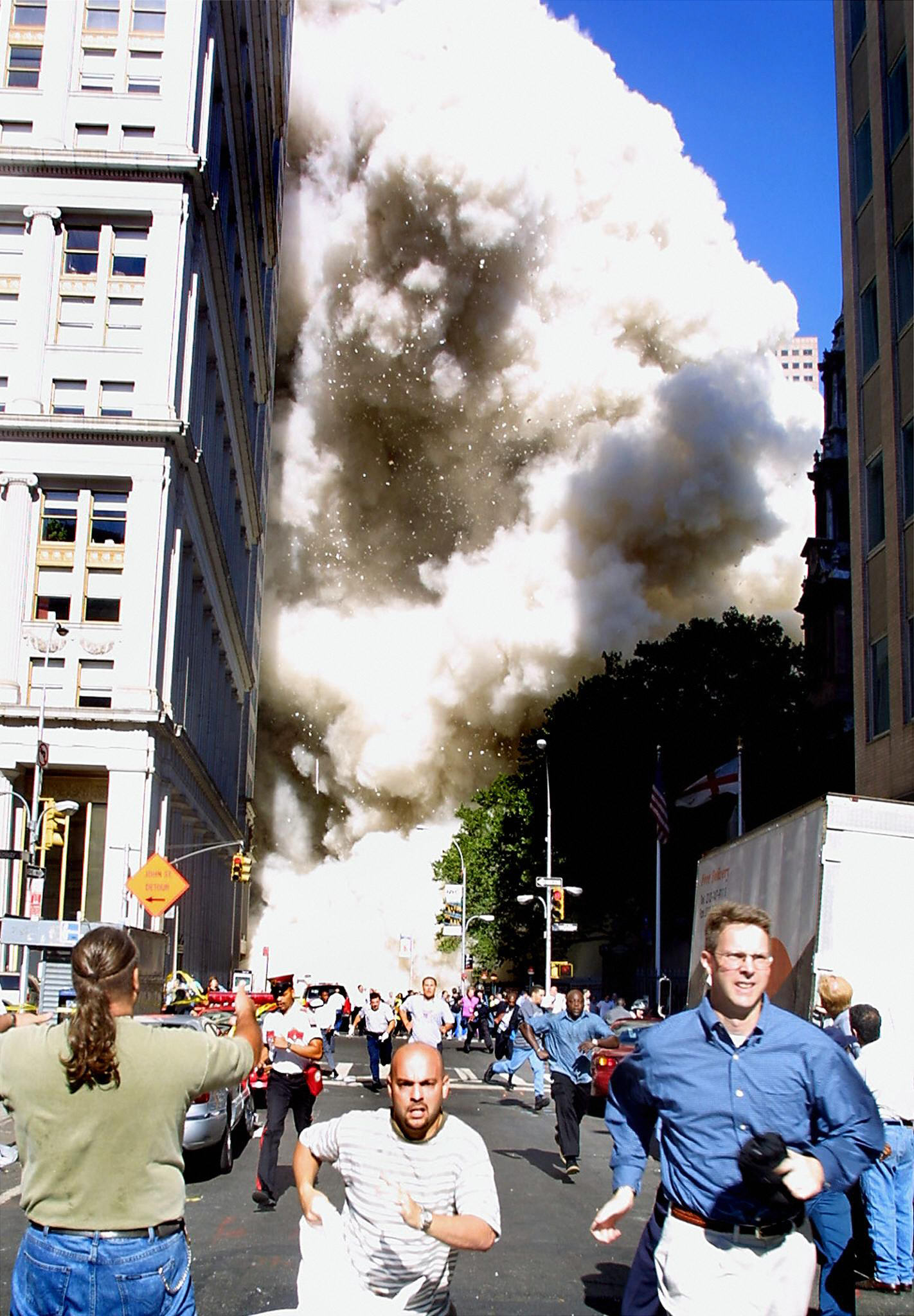 Pedestrians running from the scene as one of the World Trade Center