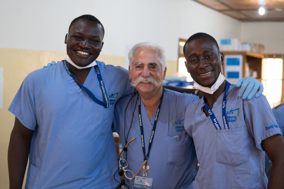Dr. Elliot Siegel with two local dental assistants in Africa. (Katie Cowell)
