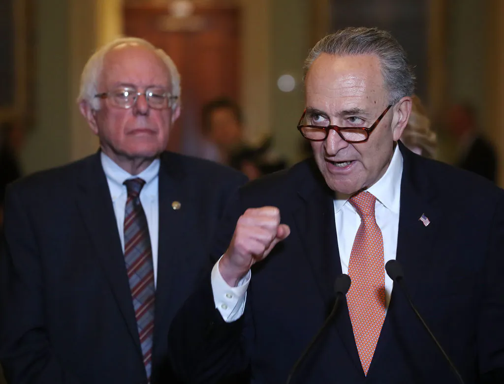 Senate Minority Leader Charles Schumer (D-N.Y.) (R) is flanked by Sen. Bernie Sanders (I-Vt.) while speaking to the media on Capitol Hill on May 23, 2017. (Mark Wilson/Getty Images)