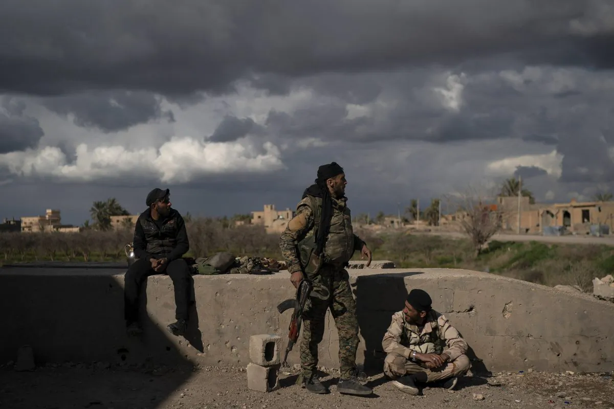 U.S.-backed Syrian Democratic Forces (SDF) fighters stand in an area recently taken by SDF as fight against ISIS continue in the village of Baghouz, Syria, on Feb. 17, 2019. (Felipe Dana/AP)