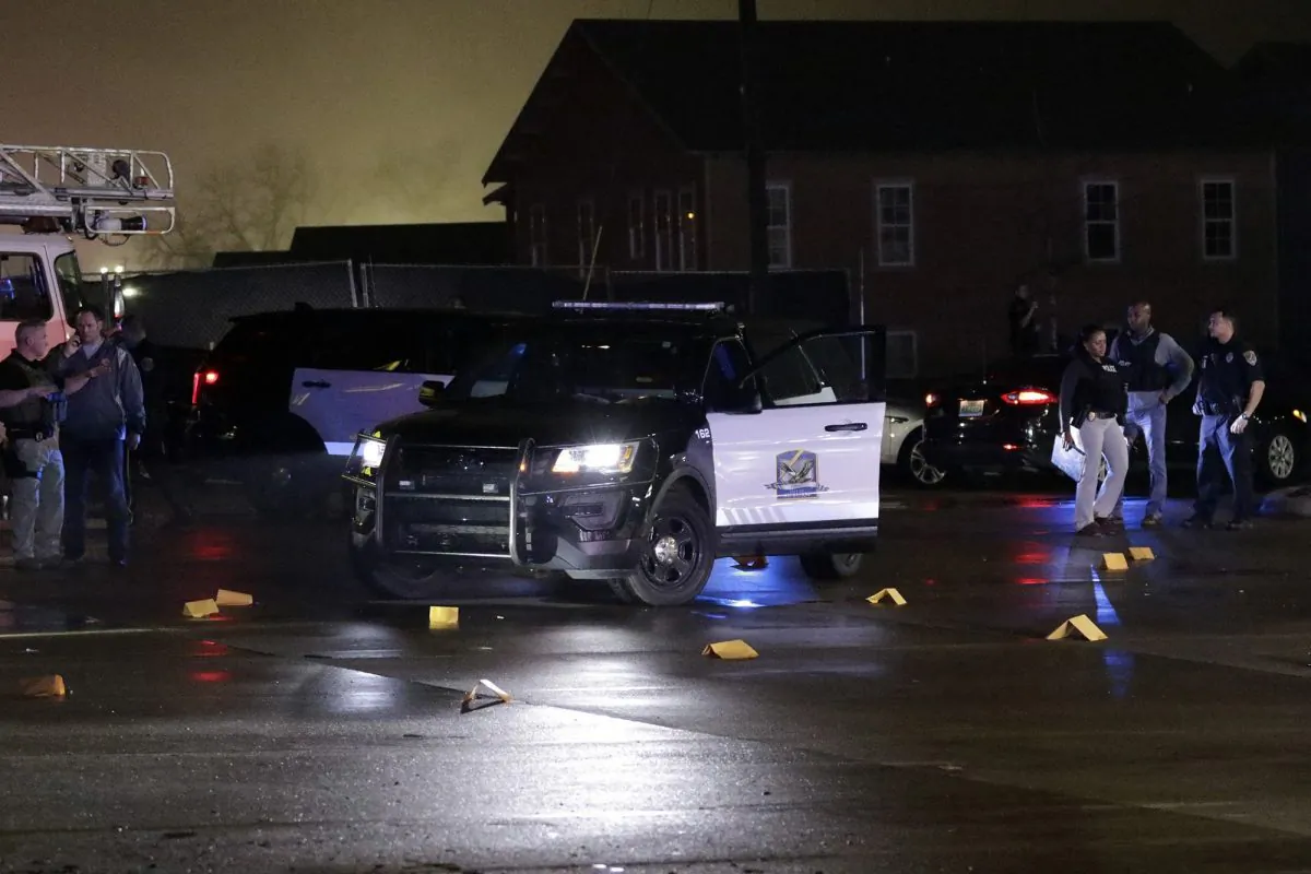 Evidence markers are placed in the Dollar General parking lot, located in the 1100 block of Opelika Road in Auburn, Ala., on Friday, Feb. 15. (Emily Enfinger/Opelika-Auburn News via AP)