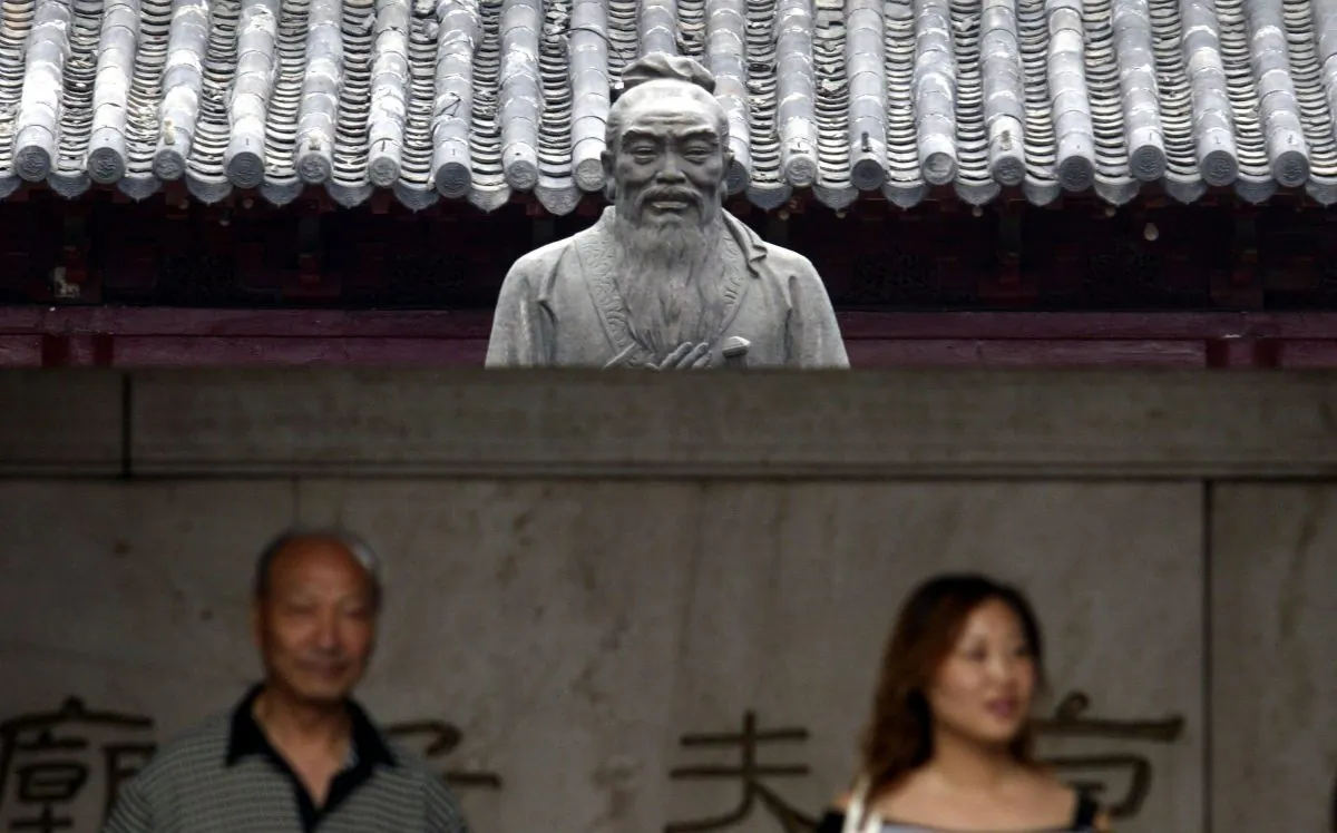 Tourists in front of a statue of Confucius in Nanjing, Jiangsu Province, China, in this file photo. (China Photos/Getty Images)