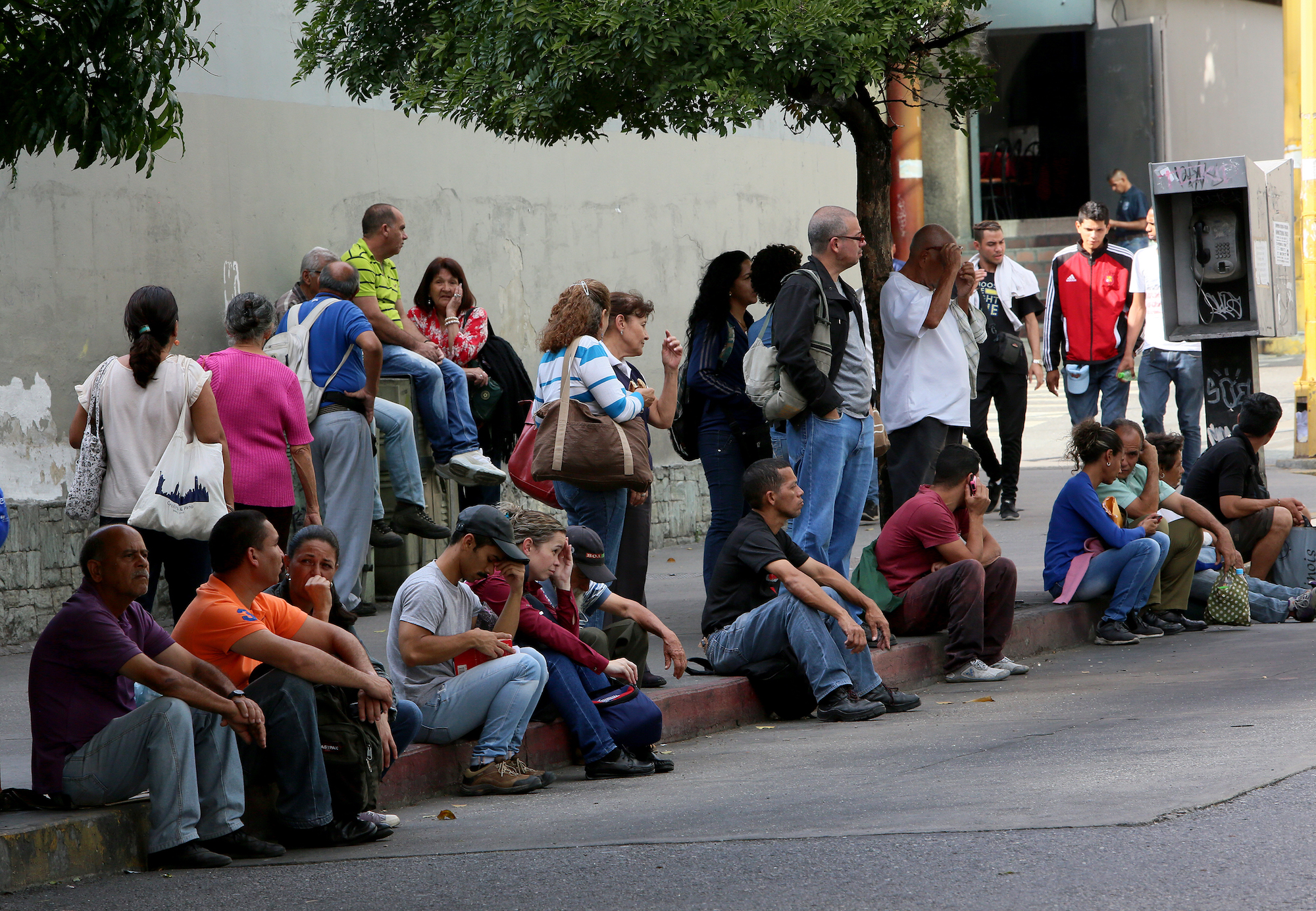 People make long queues to take the bus in Venezuela