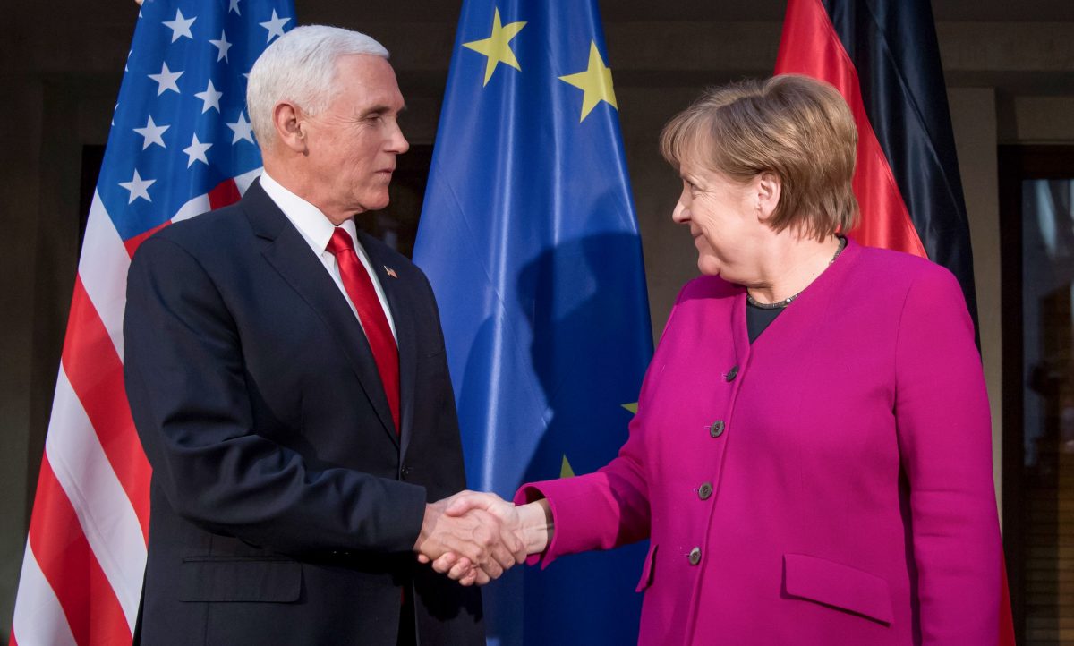German Chancellor Angela Merkel (R) and US Vice President Mike Pence shake hands at a photo call during the 55th Munich Security Conference in Munich, southern Germany