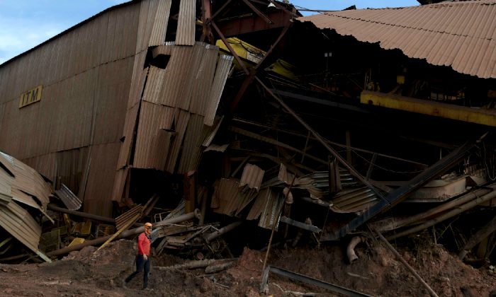 A member of a rescue team walks next to a collapsed tailings dam owned by Brazilian mining company Vale SA, in Brumadinho, Brazil on Feb. 13, 2019.