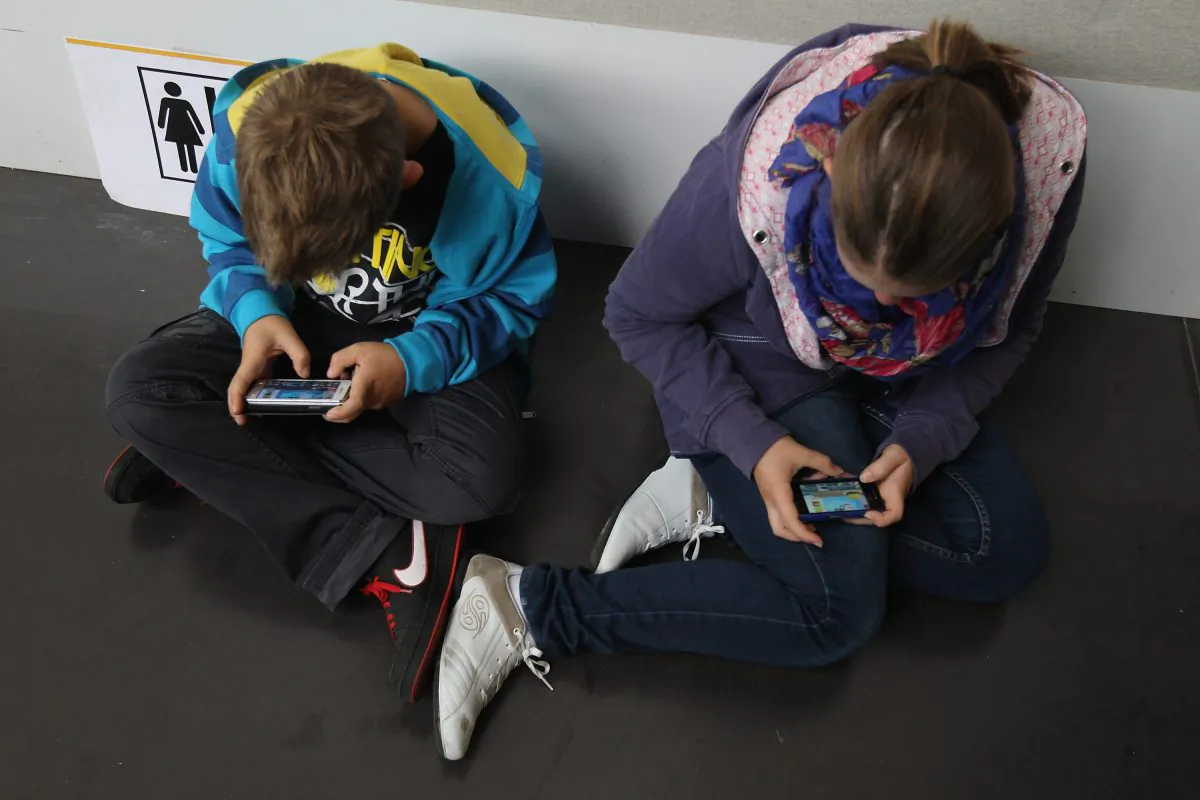 Children play video games on smartphones while attending a public event on Sept. 22, 2012 in Ruesselsheim, Germany. (Sean Gallup/Getty Images)