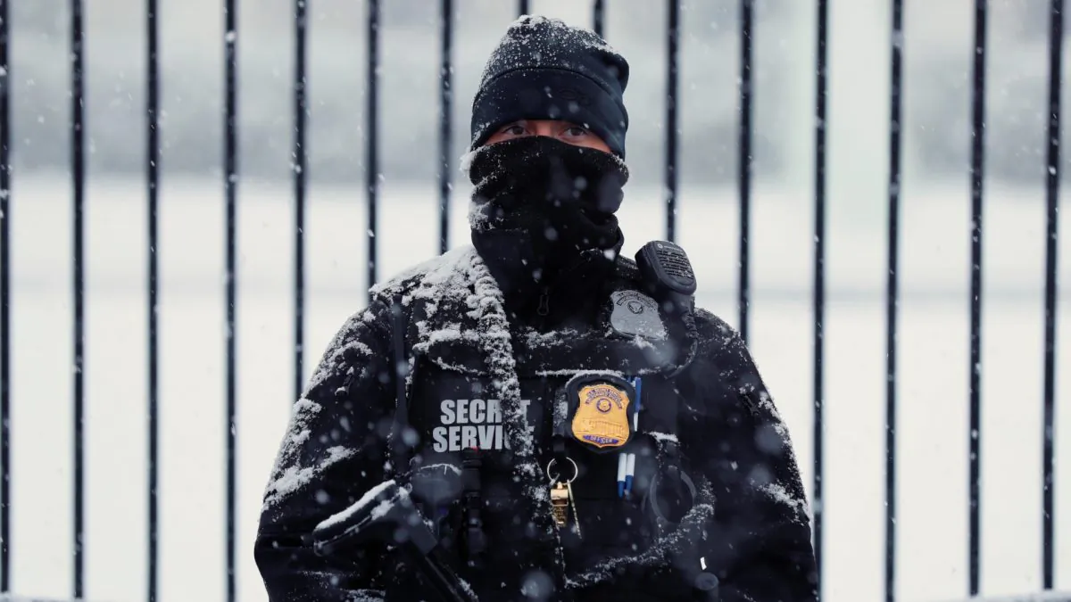 A snow covered member of the Secret Service keeps watch in front of the White House in Wash., on Feb. 20, 2019. (Kevin Lamarque/Reuters)