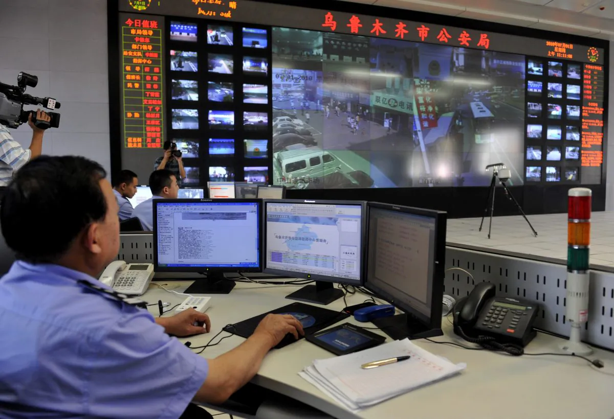 Chinese policemen watch screens showing public areas monitored by security cameras in Urumqi, China's Xinjiang region on July 1, 2010. Police have installed 40,000 security cameras throughout the capital of China's Xinjiang region, state media said.(AFP/Getty Images)