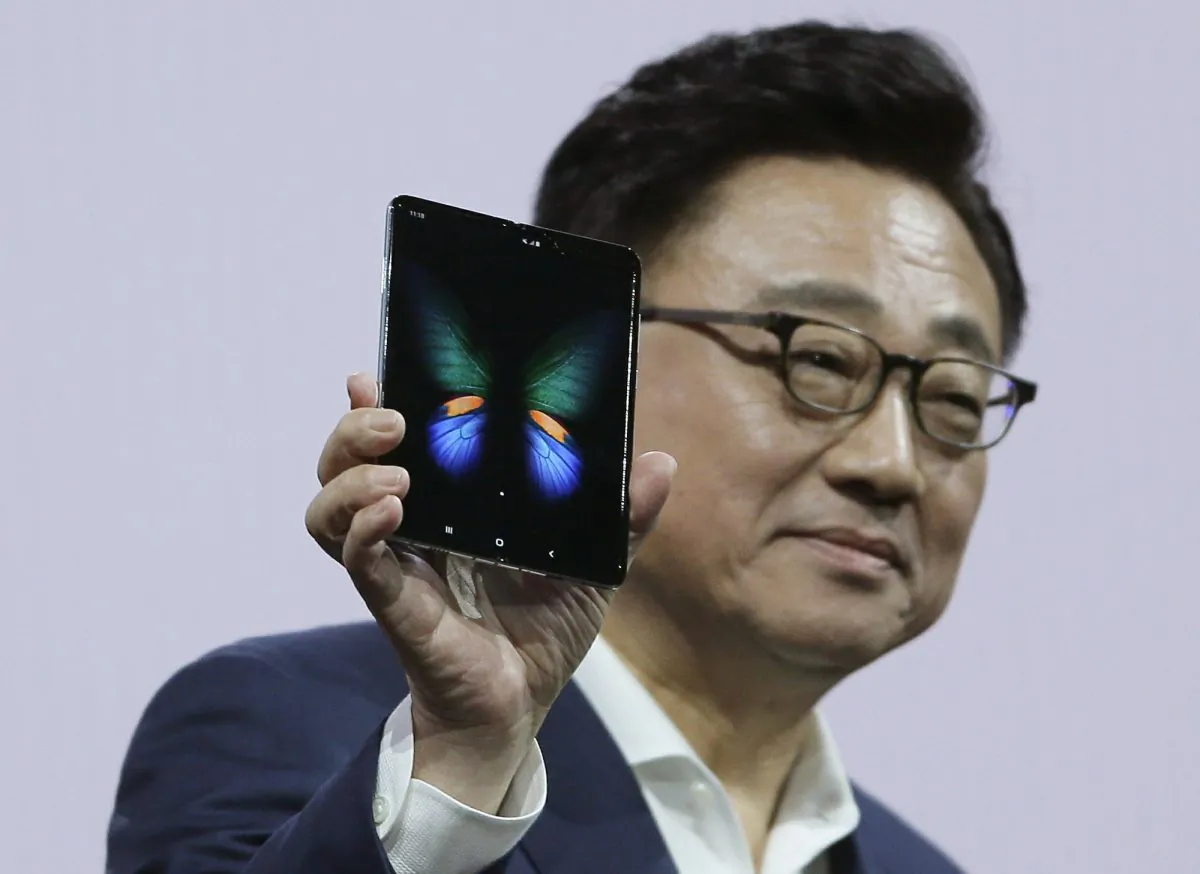DJ Koh, President and CEO of IT and Mobile Communications, holds up the new Samsung Galaxy Fold smartphone during an event in San Francisco on Feb. 20, 2019 (Eric Risberg/AP)