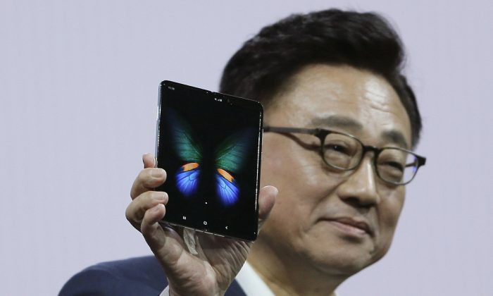 DJ Koh, President and CEO of IT and Mobile Communications, holds up the new Samsung Galaxy Fold smartphone during an event in San Francisco on Feb. 20, 2019 (Eric Risberg/AP)