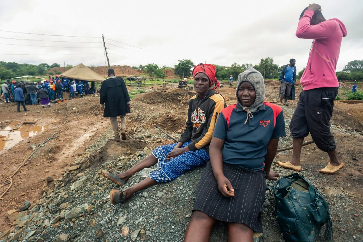 Relatives of deceased artisanal miners sit during an ongoing rescue and recovery operation at the flooded Cricket gold mine near Kadoma, Zimbabwe, on Feb. 17, 2019. (Jekesai Njikizana/AFP/Getty Images)