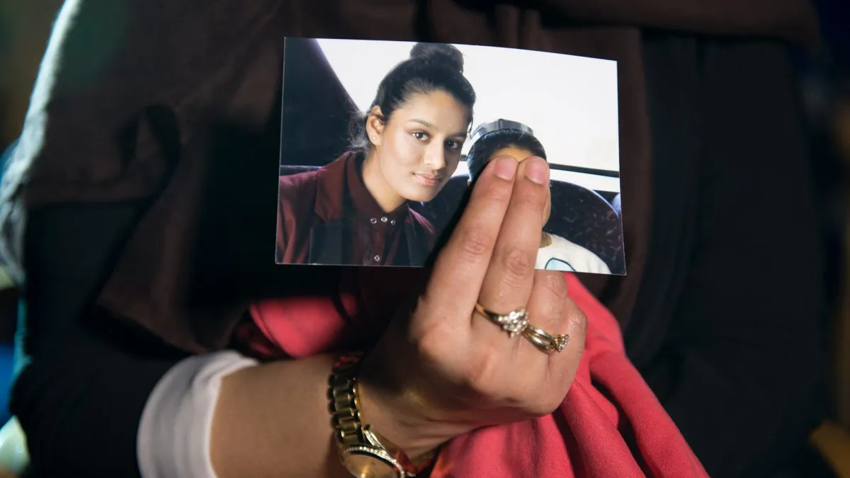 Renu Begum, eldest sister of Shamima Begum, 15, holds her sister's photo as she is interviewed by the media at New Scotland Yard, in London on Feb. 22, 2015. (Laura Lean - WPA Pool/Getty Images)
